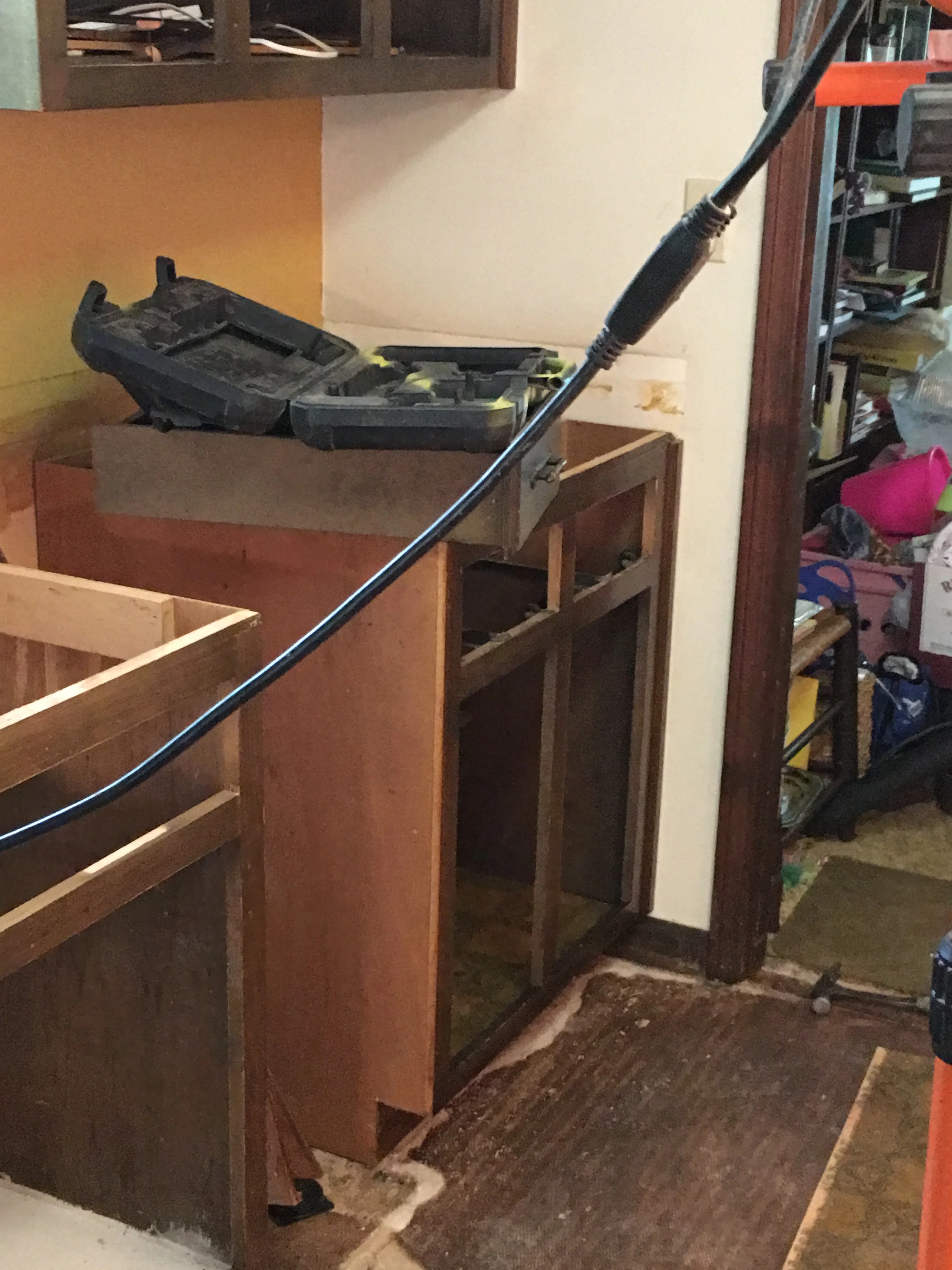 Wooden kitchen cabinets under construction with electrical wiring installed