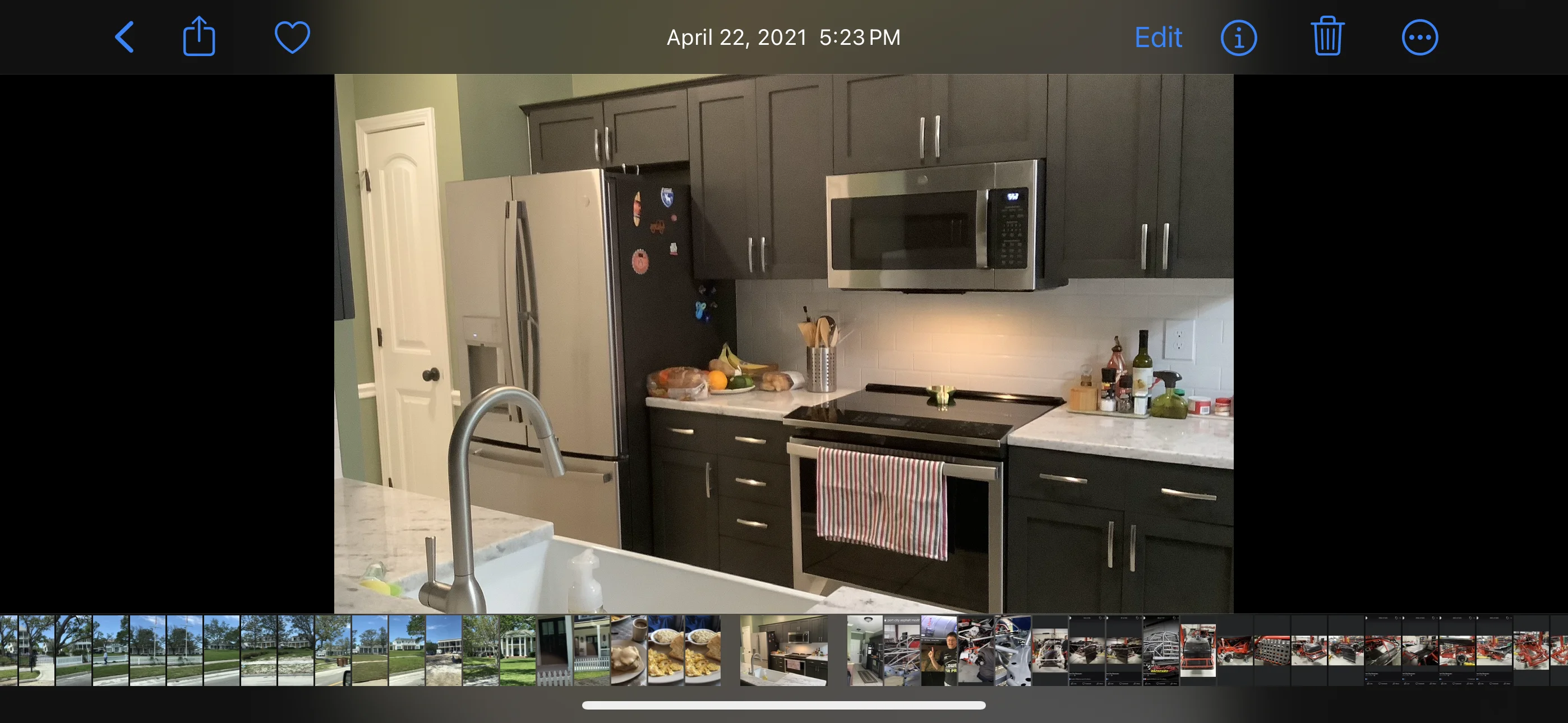 Modern kitchen with dark cabinets, white countertops, and stainless steel appliances